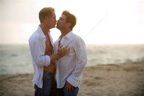 two men kissing on the beach rob lang images licensing