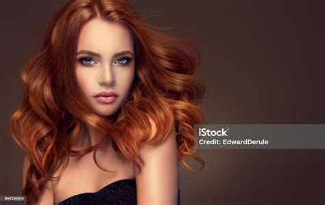 Red Haired Woman With Voluminous Shiny And Curly Hairstyleflying Hair