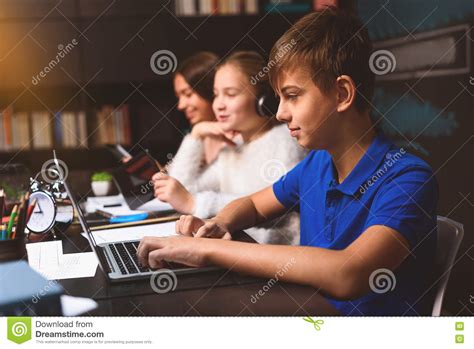 concentrated boy typing   laptop stock image image  happy