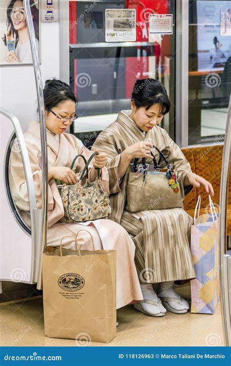 Pair Of Mature Ladies In Traditional Japanese Clothes Sitting In The