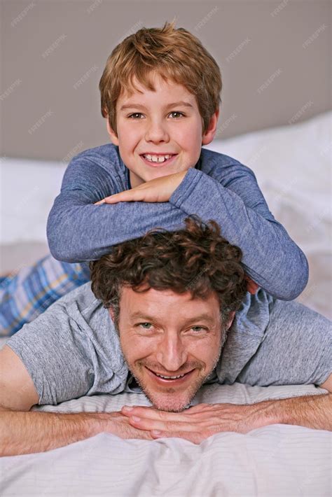 Premium Photo Like Father Like Son Shot Of A Father And Son Lying On