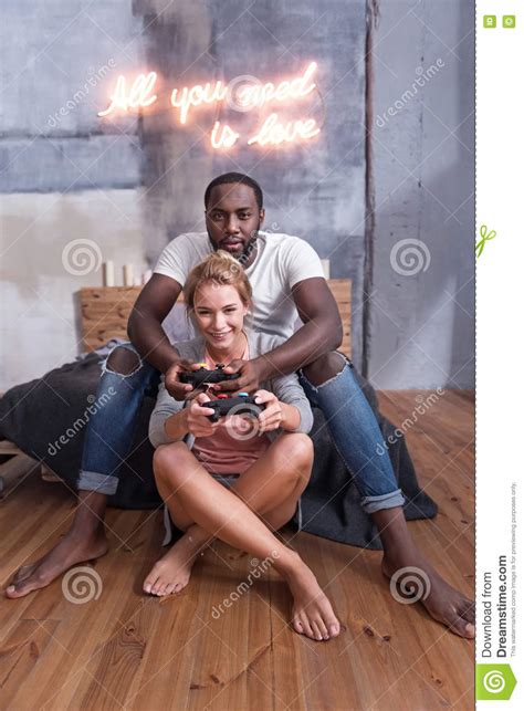 Joyful Couple Playing Video Games Together Stock Image