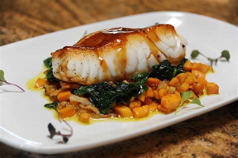Pan Seared Chilean Sea Bass With Sweet Potato Hash Sautéed Spinach And