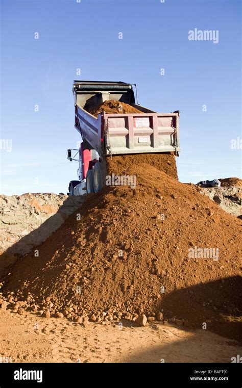 dump truck dumping fill dirt  excavated basement