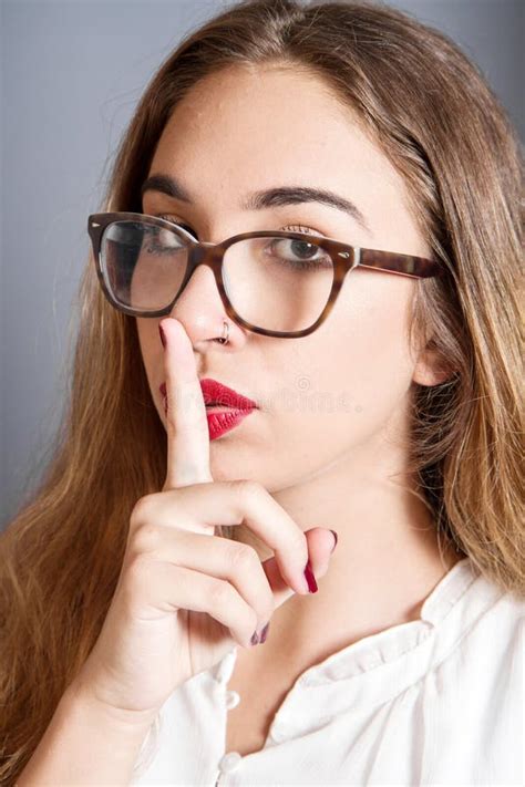 Brunette Girl With A Finger On Her Lips Showing To Keep Silence Hush