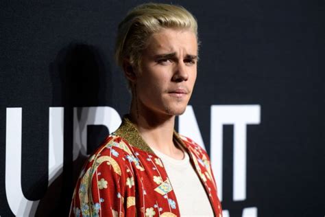 justin bieber settles paparazzo punch suit page six