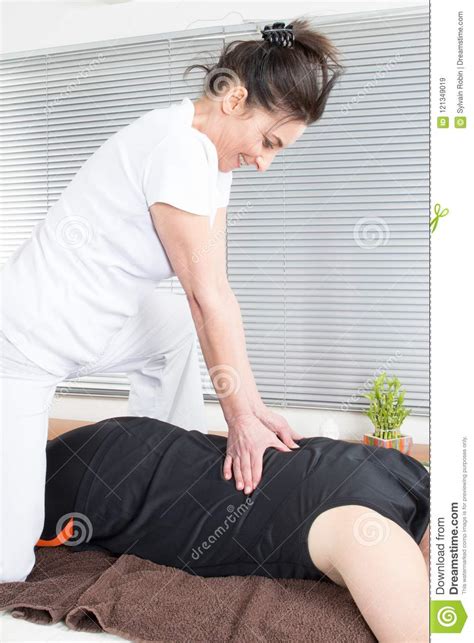 Woman Massaging Sportsman Back Applying Strong Finger Press Stock Image