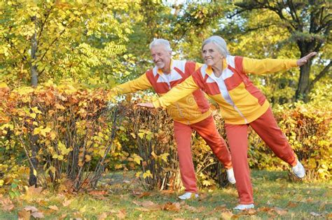 Fit Senior Couple Exercising In Autumn Park Stock Image Image Of