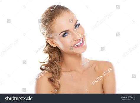 smiling beautiful blonde woman with long curly hair posing