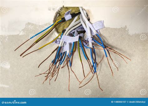 electrical exposed connected wires protruding  socket  white wall electrical wiring