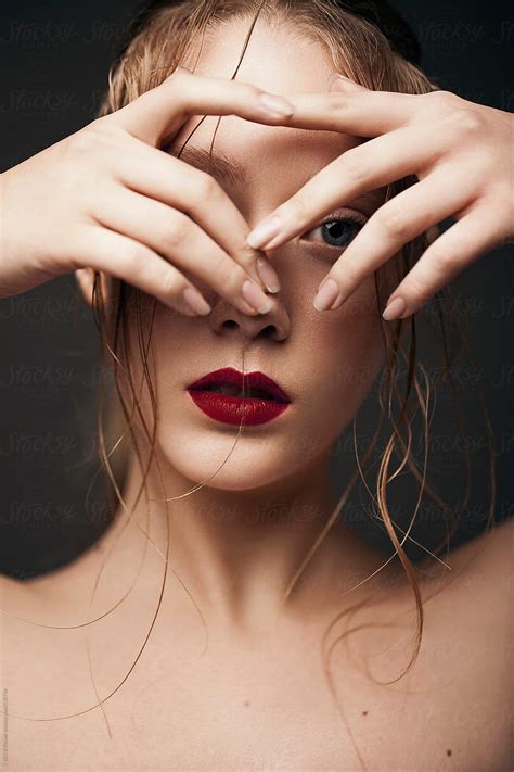 portrait of a beautiful girl with wet hair and red lips by stocksy