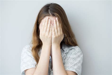 shy girl covering   face   hands stock photo image  teenager hide