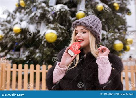 Lovely Young Woman In Grey Knitted Hat Holding Delicious Ginger Stock