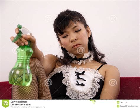 asian maid holds a spray bottle stock image image of