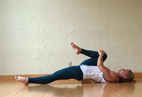 Lie Down On Your Back And Place A Yoga Block Under Your Hips Bend Your