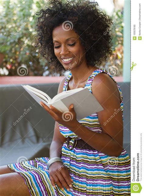 Beautiful Mature Woman Smiling And Reading Stock Image