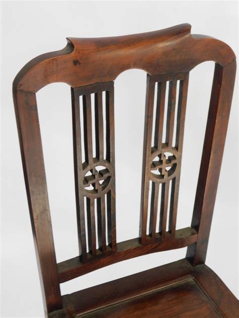 a chinese hardwood chair with pierced splat back with buddhistic