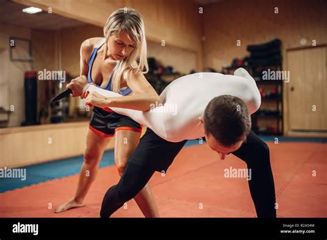 Woman Makes Elbow Kick Self Defense Workout With Male Personal Trainer