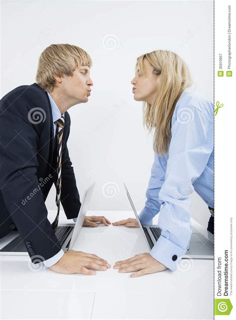 Side View Of Business Couple Kissing In Office Stock Image