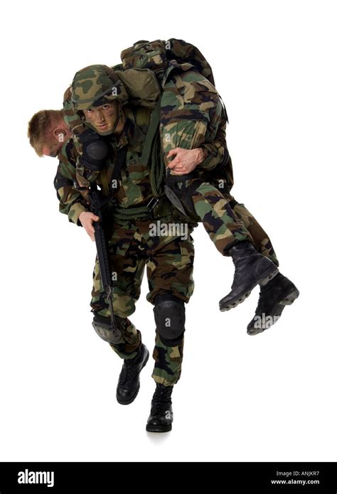 soldier carrying  injured soldier   shoulders stock photo
