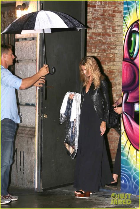 heidi klum is practically naked under a shield of hangers for project