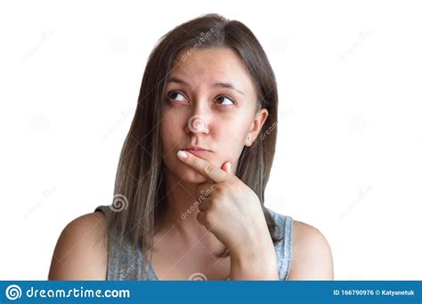Pretty Brunette Girl In A Thoughtful Expression With A Finger On Her