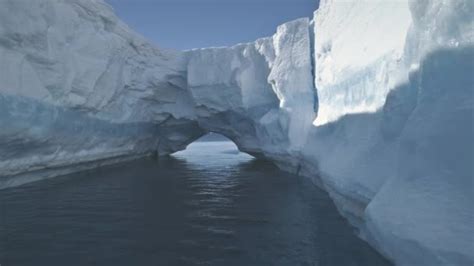 aerial drone flight  antarctica iceberg arch stock video  mozgova