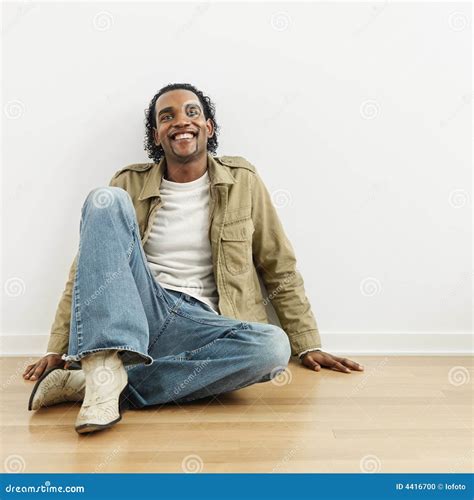 man sitting  floor stock photo image  african male
