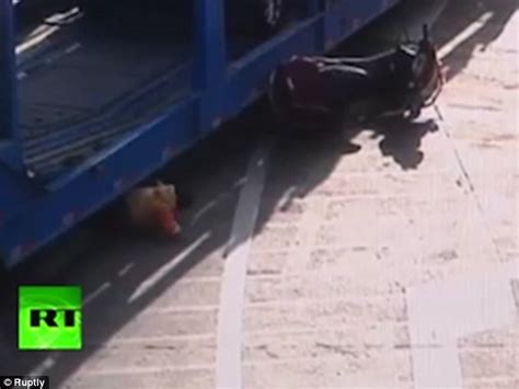 father and daughter narrowly escape being crushed to death by a truck in china daily mail online