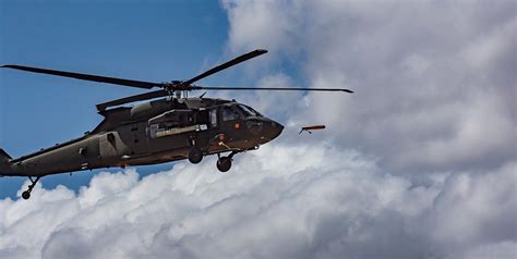 black hawk helicopters   launch drones  midair
