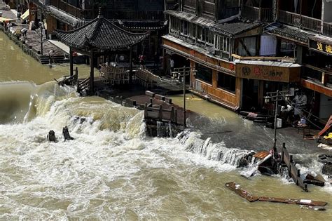 chinas hunan province floods villages buried  landslides crops