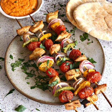 hungry couple grilled chicken skewers  roasted red pepper sauce