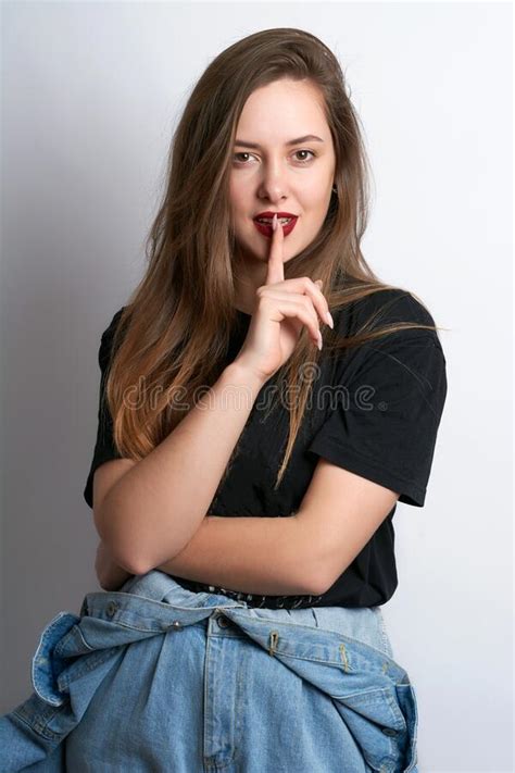Beautiful Girl With A Finger At The Mouth On A White Background Stock