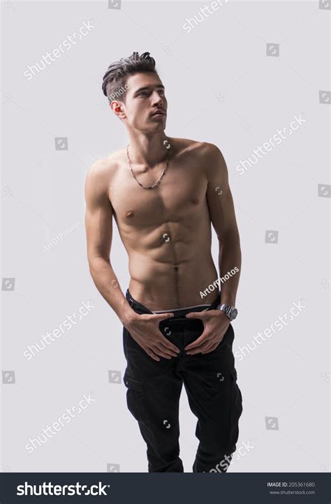 lean athletic shirtless young man standing stock photo