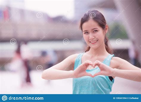 Smile Cute Asian Girl Teen Love Heart Hand Sign Stock