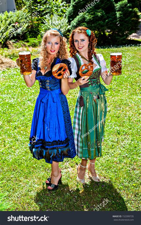 Two Girls In Dirndl Dress Holding Oktoberfest Beer Stein