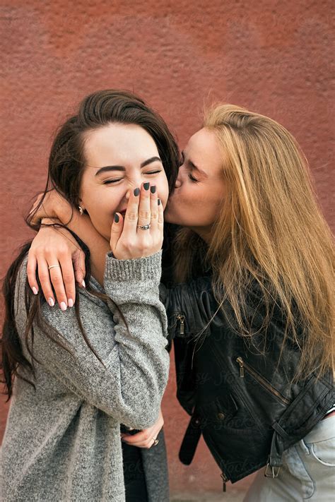 Blonde Girlfriend Kissing Brunette With Eyes Closed By Stocksy