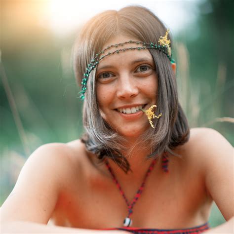 Portrait Of A Woodstock Hippie Style Girl With Flower In The Mo