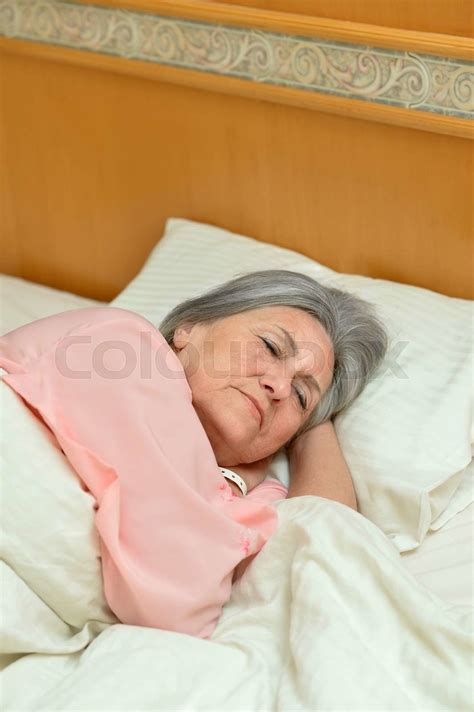 Mature Woman Sleeping In Bed Stock Image Colourbox