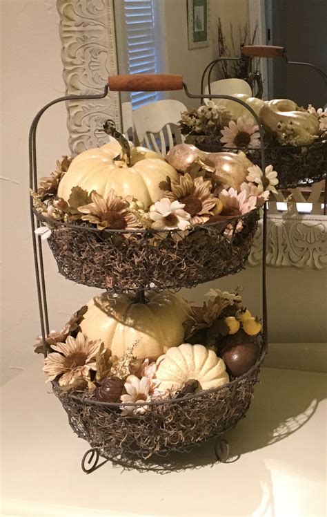 tiered baskets filled  fake pumpkins  flowers  top