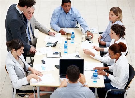 business meeting executives gathered  aroung  table athena