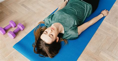 slim woman lying  shavasana pose  yoga mat  stock photo