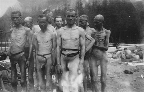A Group Of Emaciated Jewish Survivors Stand Outside In The Ebensee