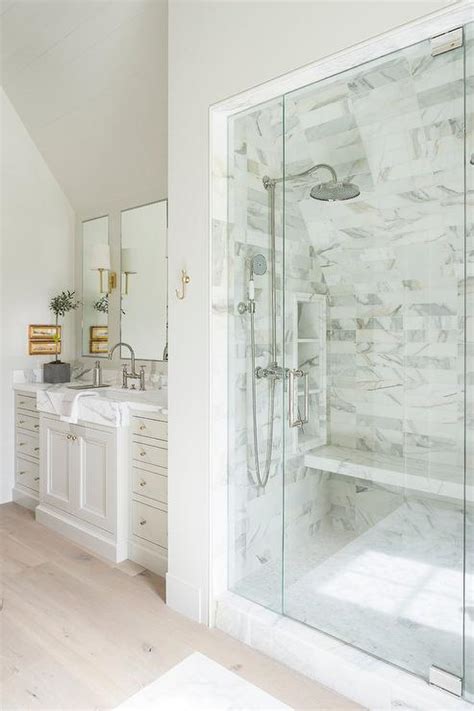 Glass Walk In Shower With Sloped Ceiling Over Marble Floating Bench
