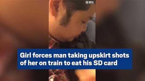 Watch Girl Forces Man Taking Upskirt Shots Of Her On Train To Eat His