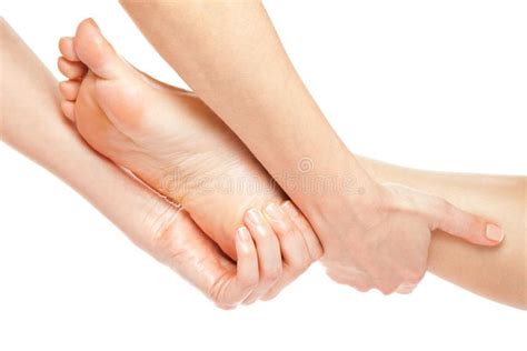 foot massage woman hands giving a gentle foot massage isolated on