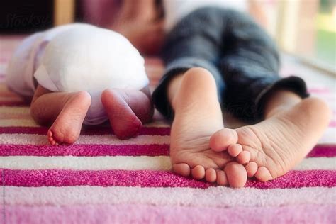 close    young childs feet lying    newborn sisters