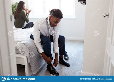 business couple in bedroom getting ready for work