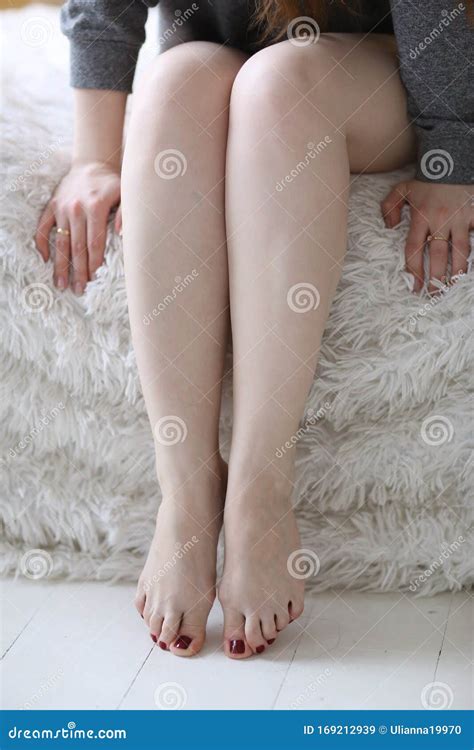 Women Bare Legs And Feet With Red Pedicure Close Up Photo Stock Image
