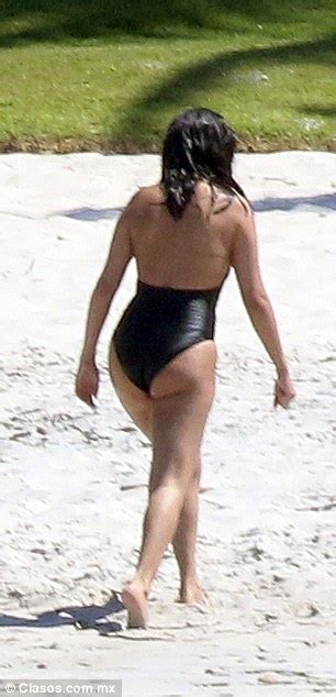 selena gomez displays her sensational curves in a sexy plunging swimsuit as she cools off in the